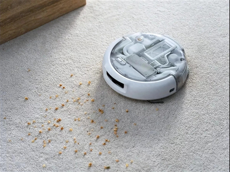 DJI ROMO 2 Sweeping and Mopping Robot · The robot is on the carpet, and there are debris particles around it that need to be cleaned up_1200_900_1200_900.jpeg
